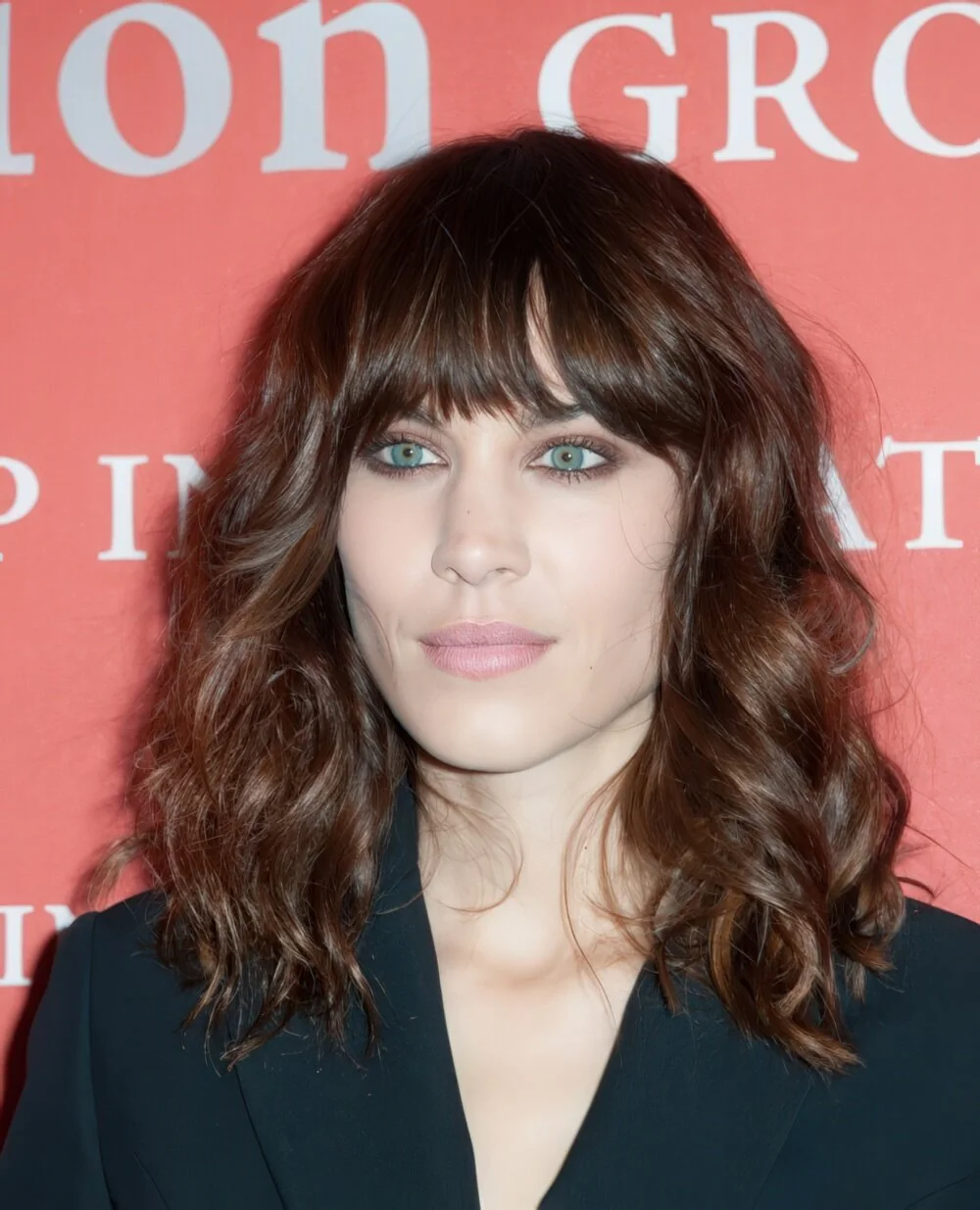 Shaggy brunette wavy lob with full fringe.