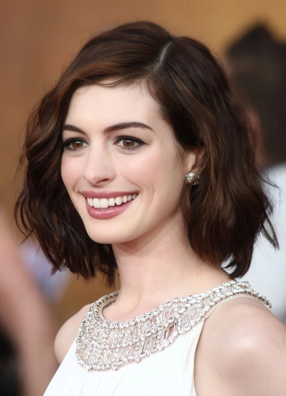 Glossy dark wavy bob with a side part.
