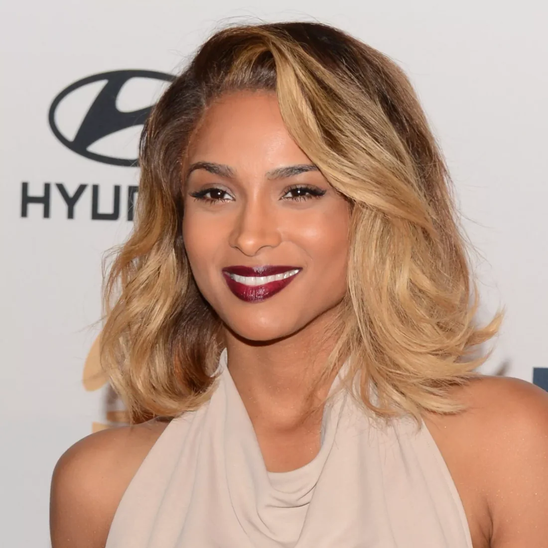 Soft celebrity wavy lob with side-swept volume.
