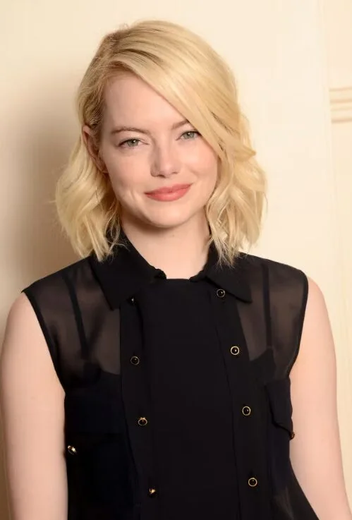 Soft blonde wavy lob with relaxed bends.