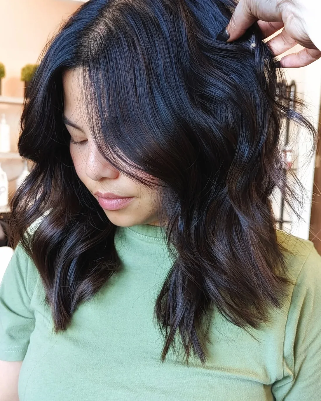 Dark glossy wavy lob with deep side part.