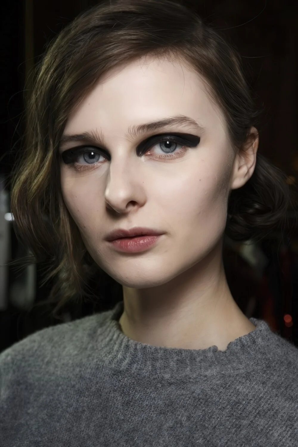 Sleek dark faux bob with a side part.