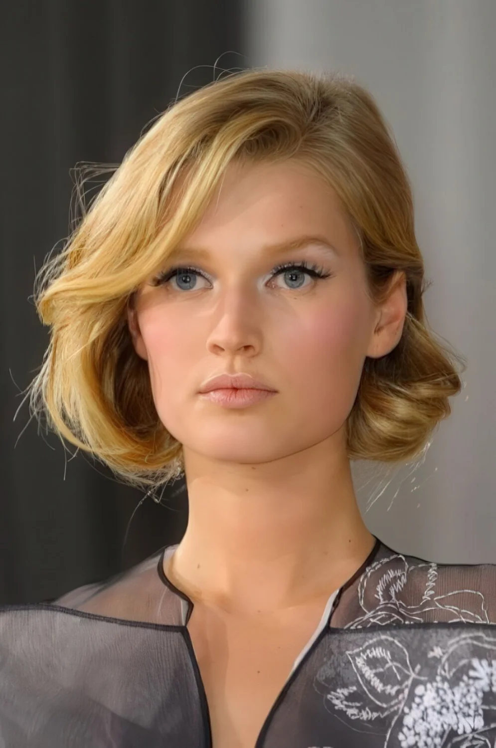 Flipped blonde faux bob with a side part.