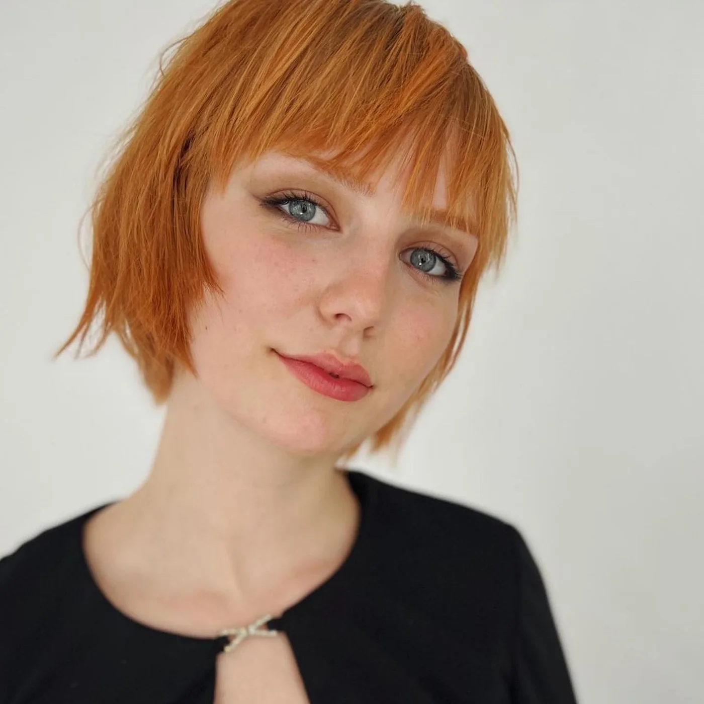 ear straight copper pixie with wispy fringe shown as a thin hair hairstyles short idea, featuring straight texture