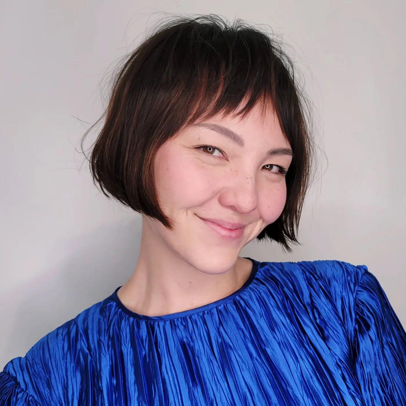 chin straight brunette bob with micro fringe shown as a thin hair hairstyles short idea