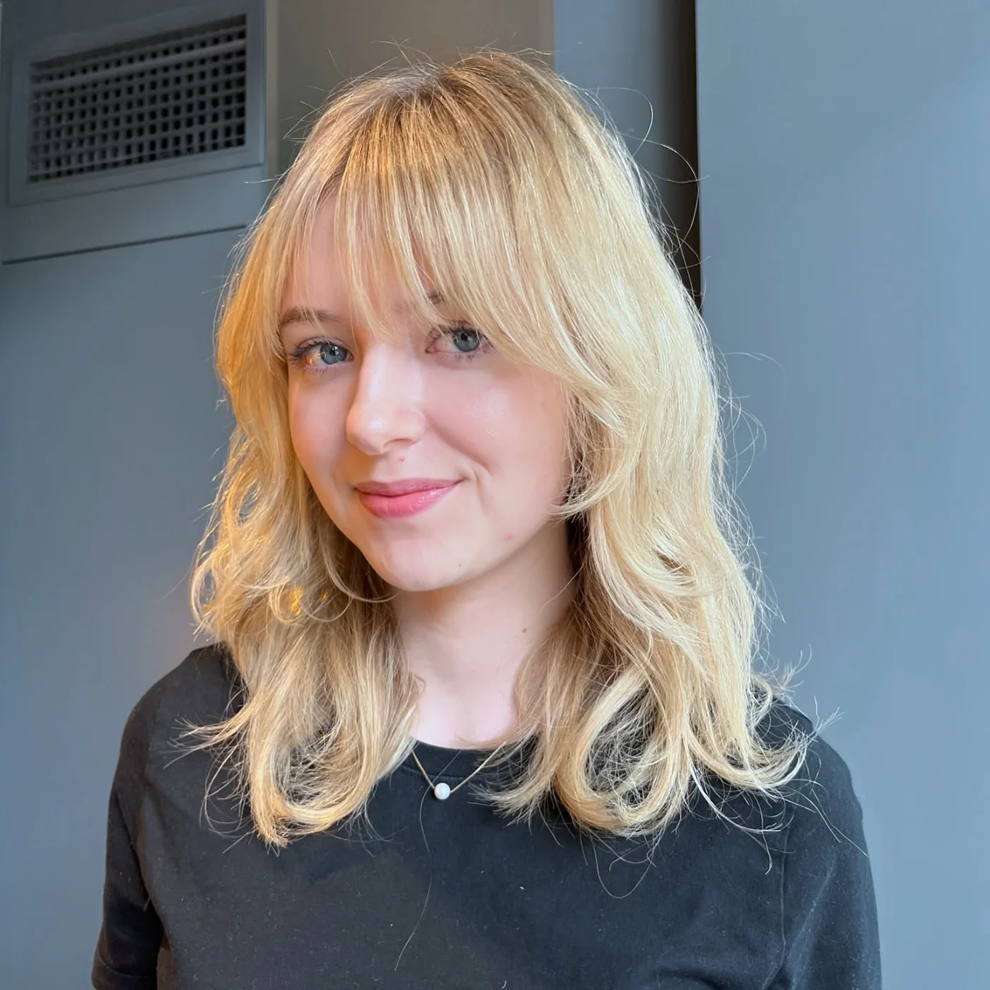 shoulder wavy blonde shag with wispy fringe shown as a thin hairstyles with bangs idea