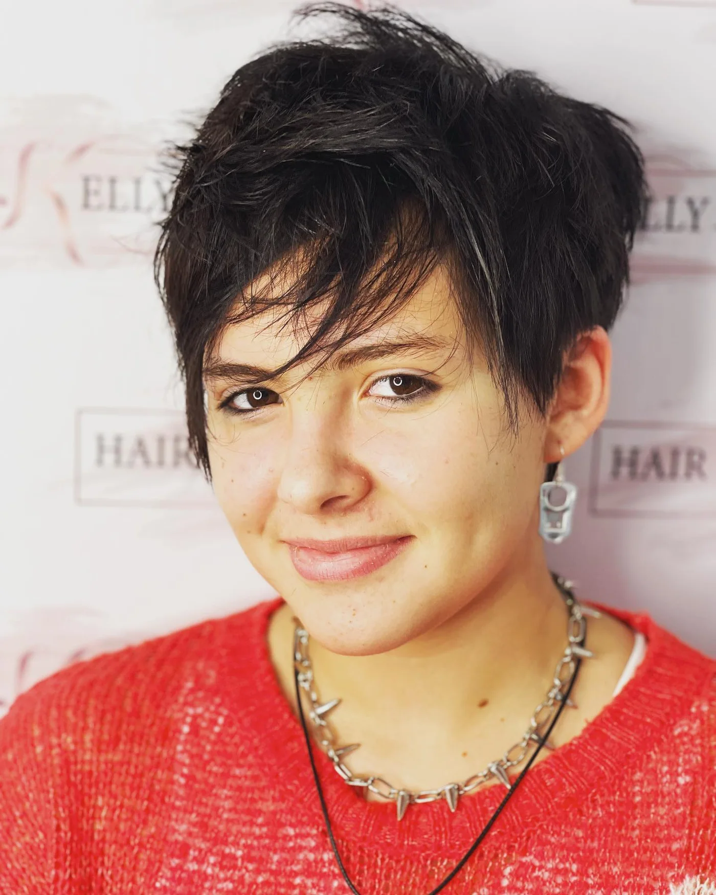ear straight golden pixie with wispy fringe shown as a thin hairstyles with bangs idea, featuring volume through the crown, shown in dark pixie with wispy fringe
