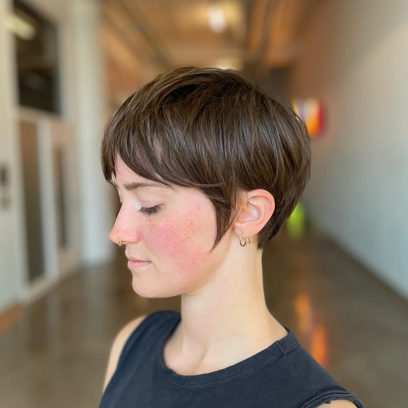 ear straight golden pixie with wispy fringe shown as a thin hairstyles with bangs idea, featuring straight texture, shown in short brown pixie with micro bangs