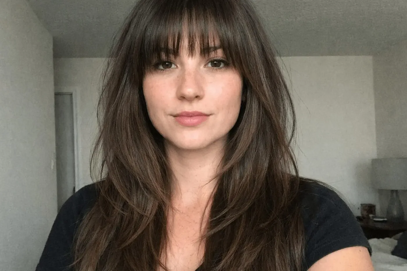 chest wavy chestnut layers with curtain fringe shown as a thin hairstyles with bangs idea