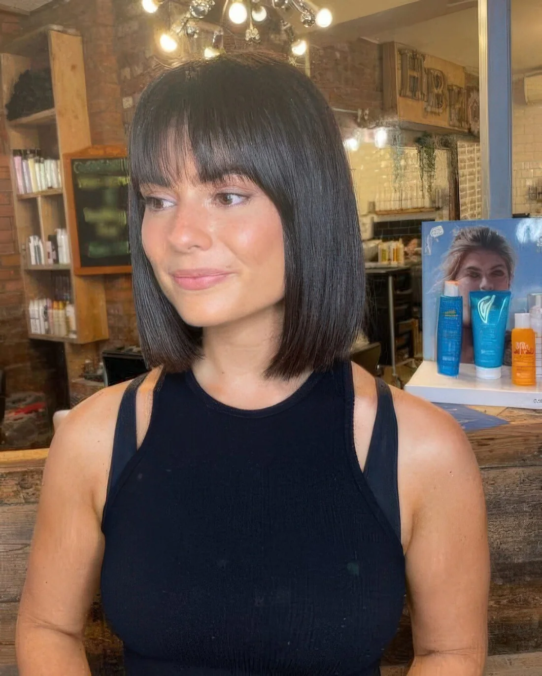Classic dark brown blunt bob with blunt bangs.