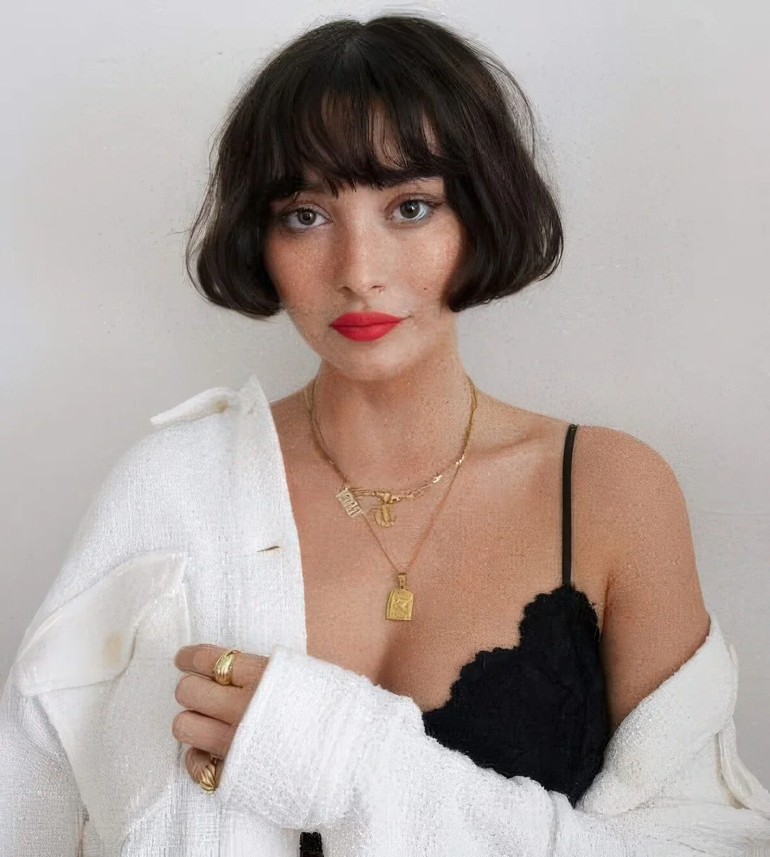 French blunt bob in dark brown, with waves and bans.