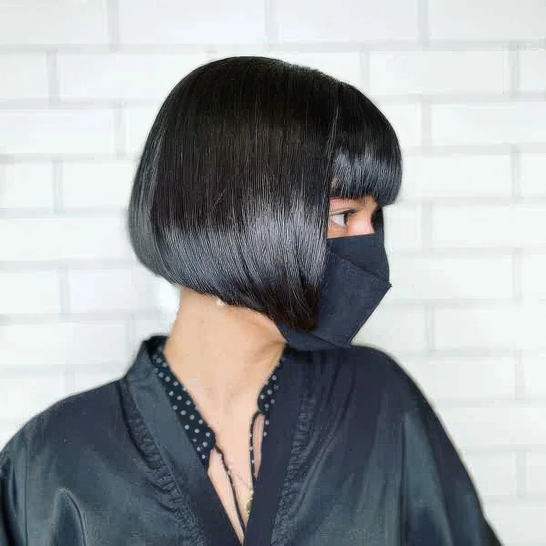 Photo showing shiny black ear-length blunt bob, with the hairstyle clearly visible.