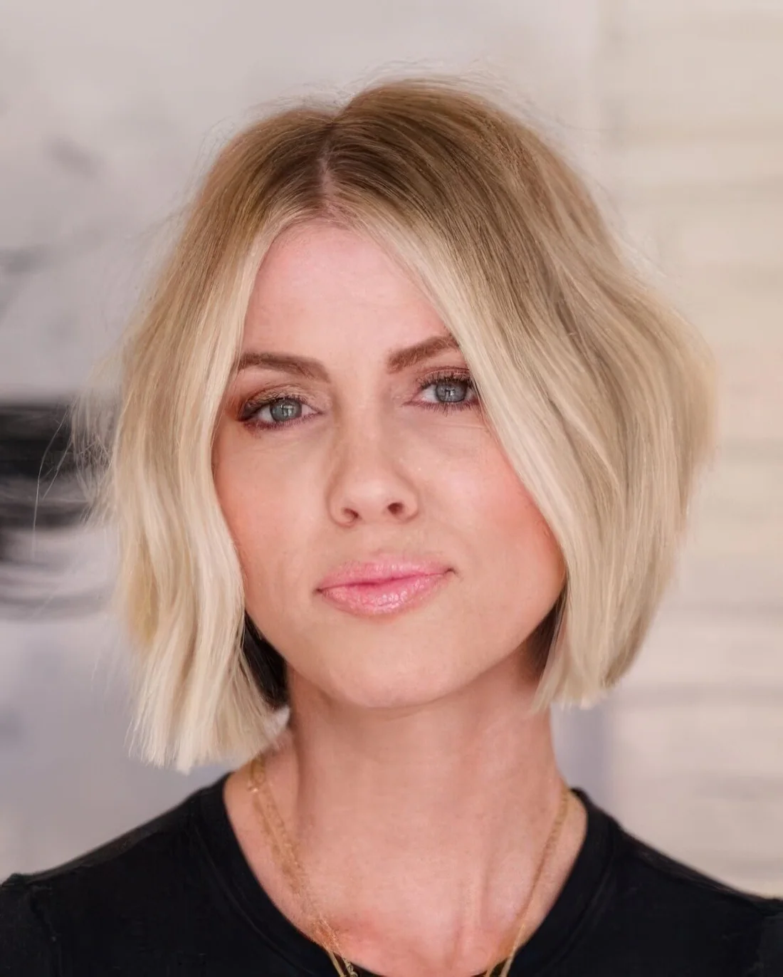 Short blonde bob haircut with balayage that brigns texture and volume to the look.