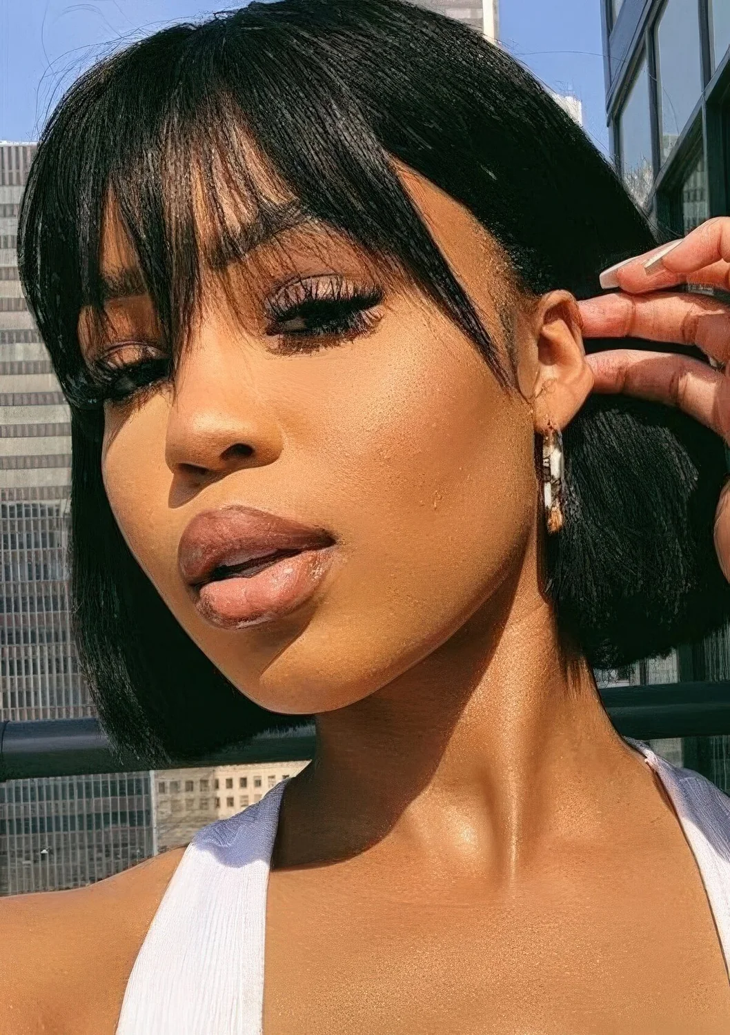 Short blunt bob with outgrown wispy bangs in black.