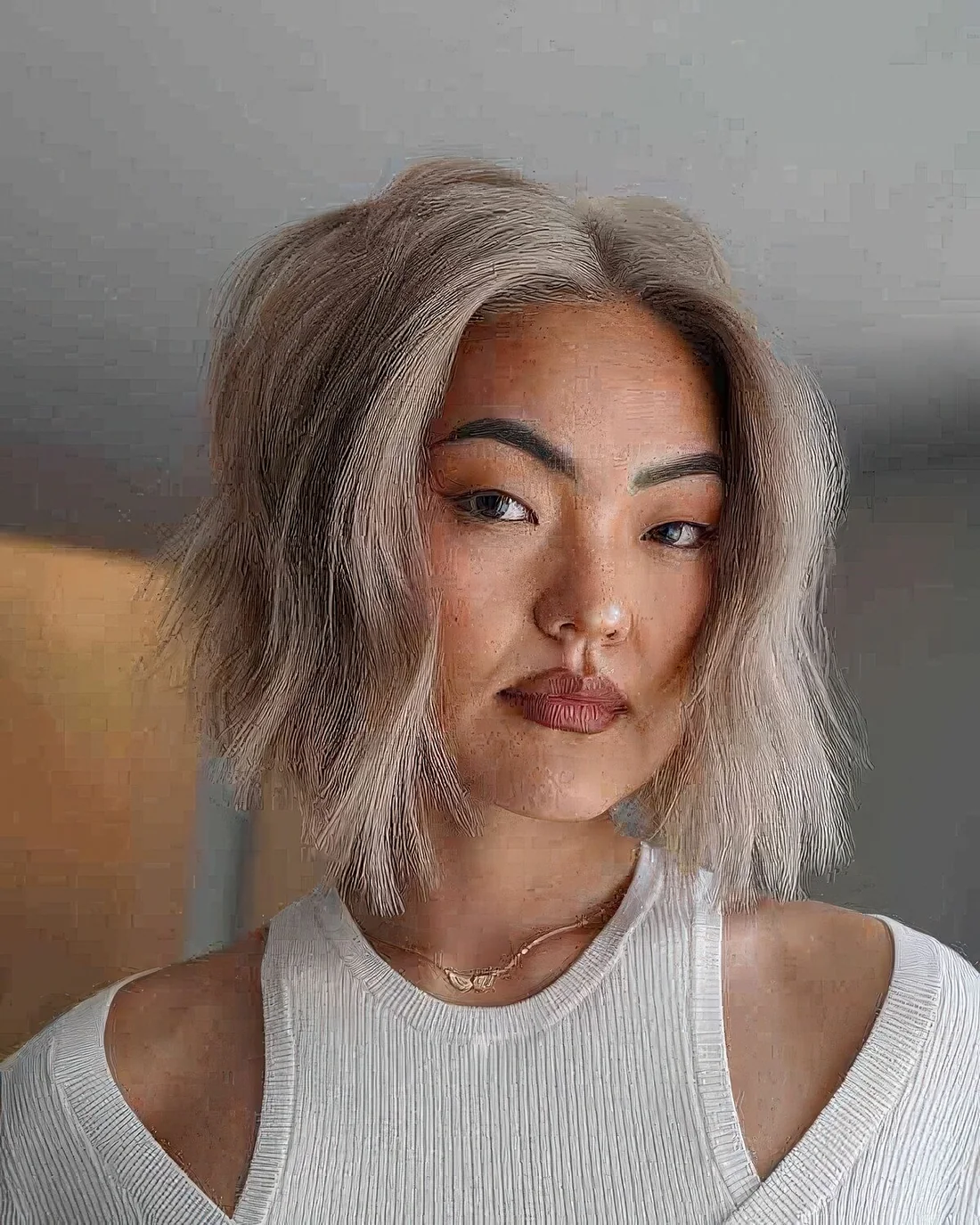 Icy blonde soft blunt haircut with invisible layers.