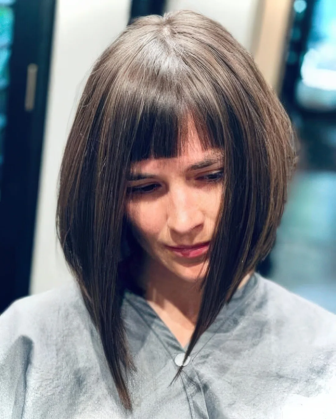 Shoulder-length blunt bob with blunt bangs.