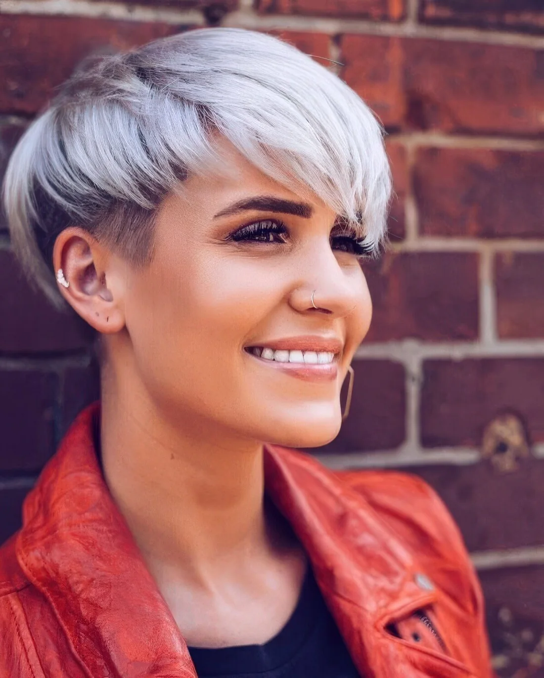 Icy blonde bowl haircute styled irregular for a more eye catchy and bold look.