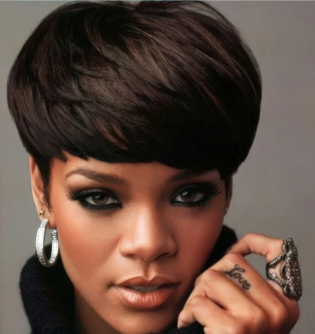 Rihanna wearing a dark bowl haircut.