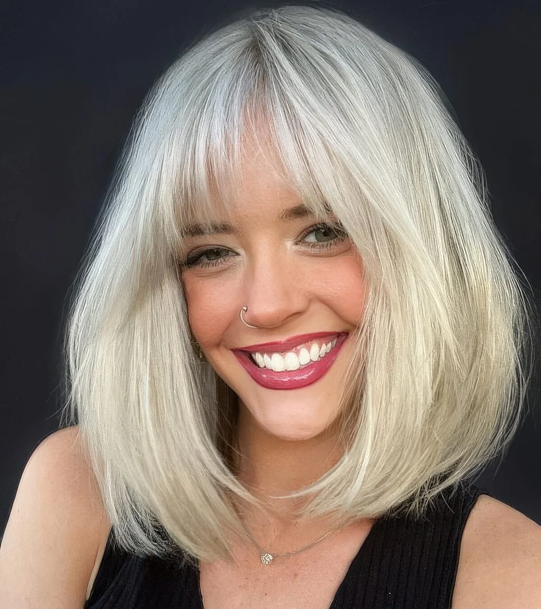 Bottleneck and curtain bangs blonde.