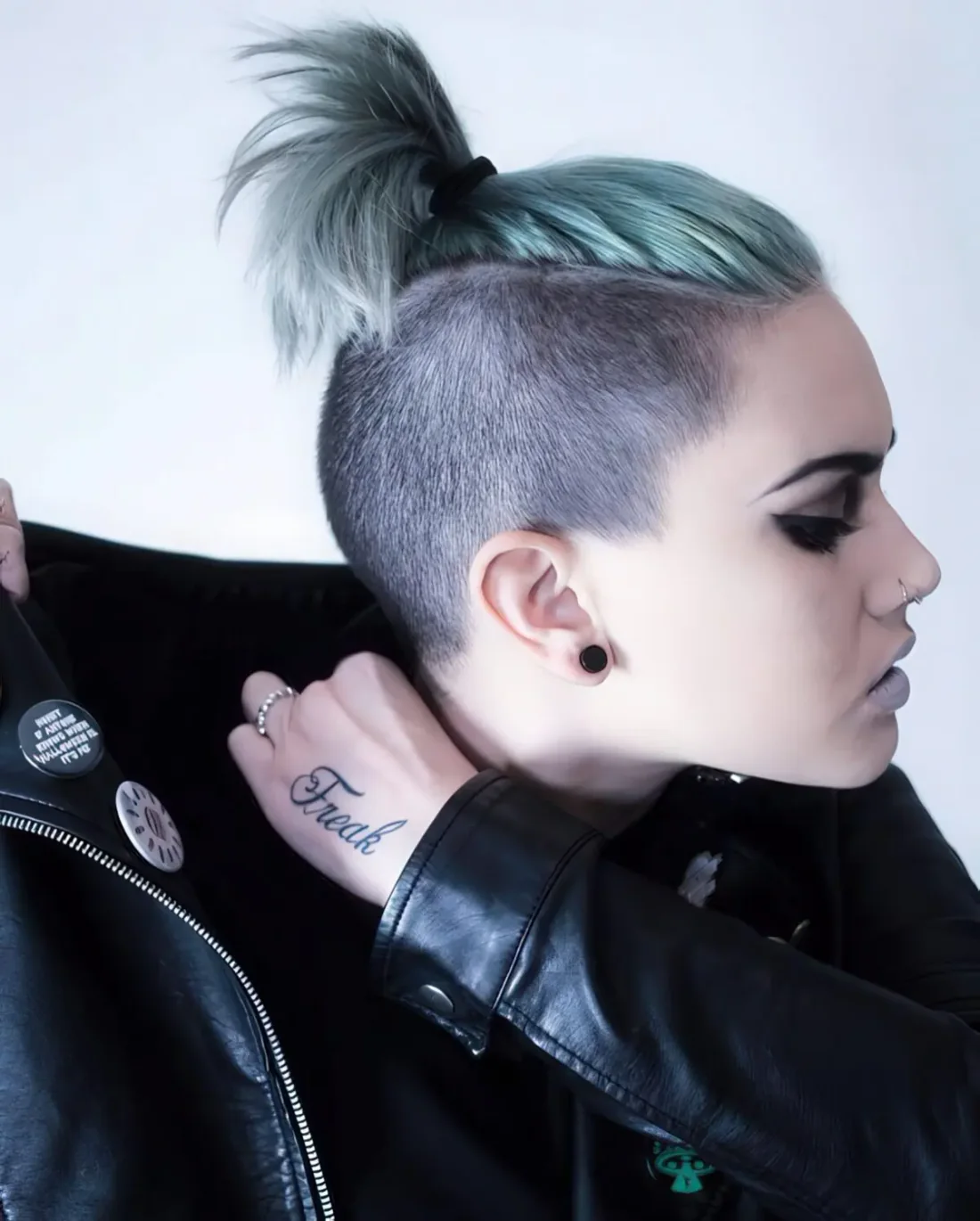 Light aqua long undercut pixie with a ponytail.