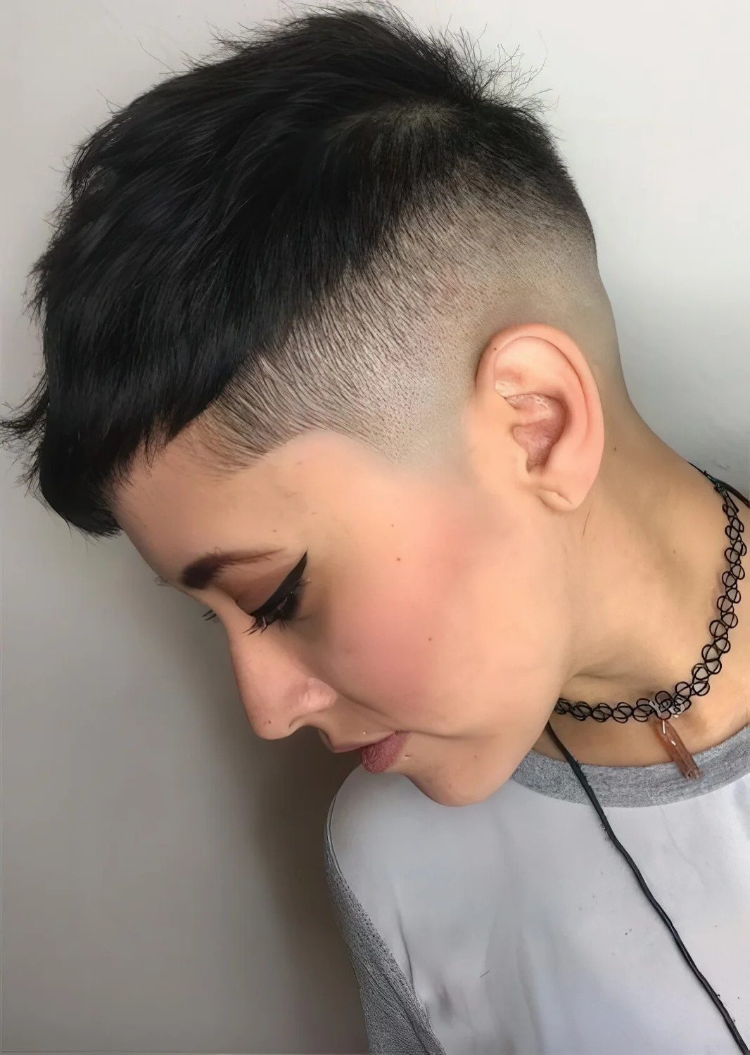 Photo showing short undercut pixie in black, with the hairstyle clearly visible.