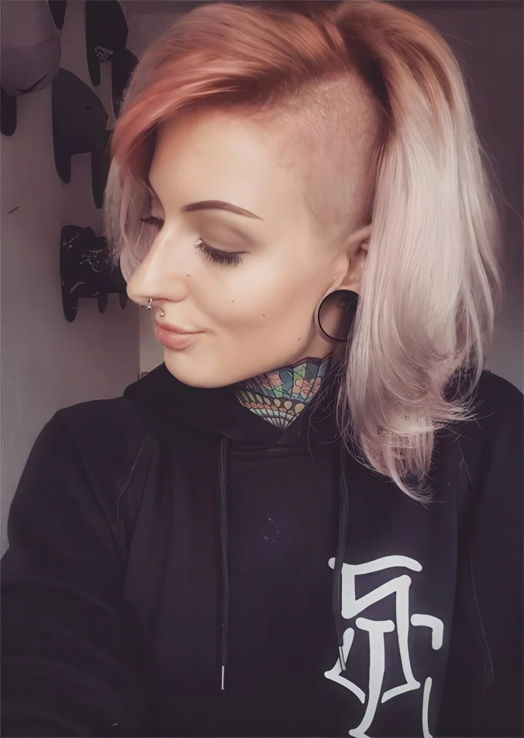 Ombre pink to blonde short bob with an undercut part.