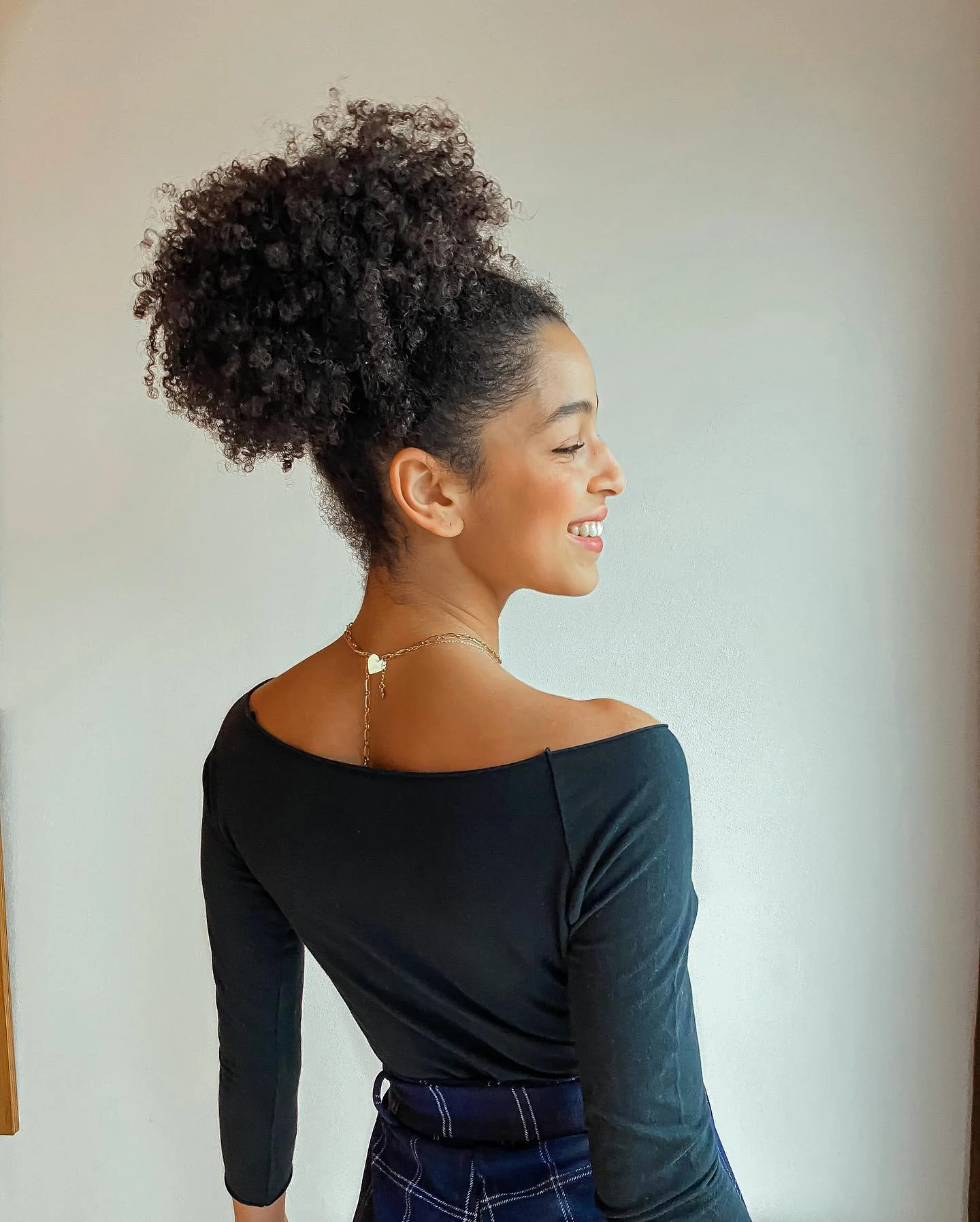 shoulder coily black bun shown as a updos for fine thin hair idea