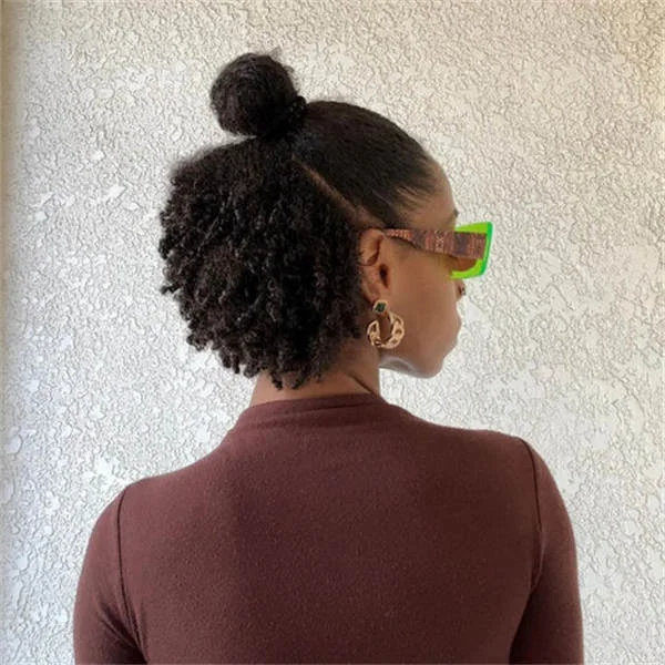 shoulder coily black bun shown as a updos for fine thin hair idea, featuring coily texture