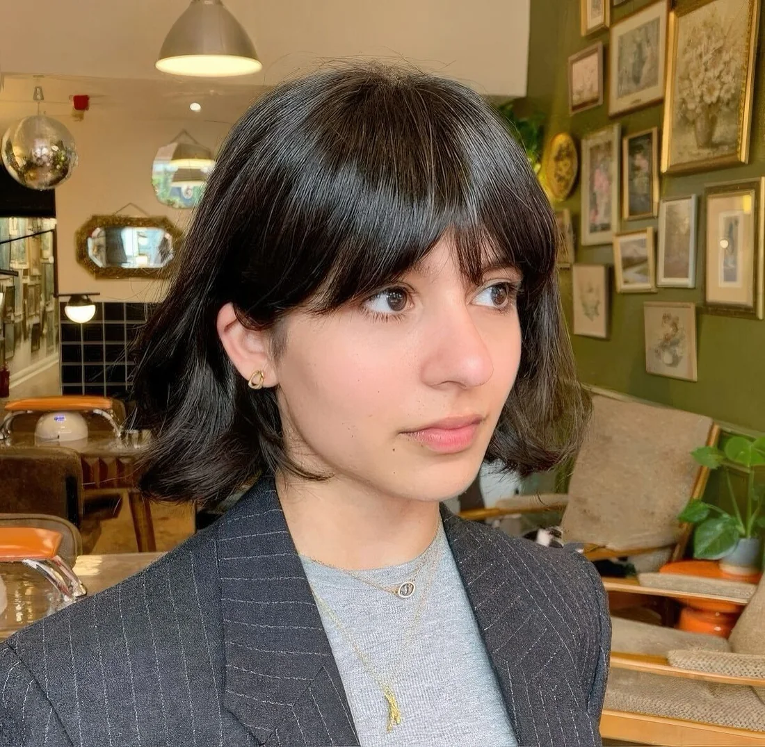 Photo showing dark bob bottleneck bangs, with the hairstyle clearly visible.