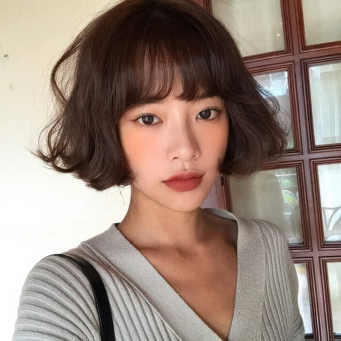 Photo showing french bob bangs, with the hairstyle clearly visible.