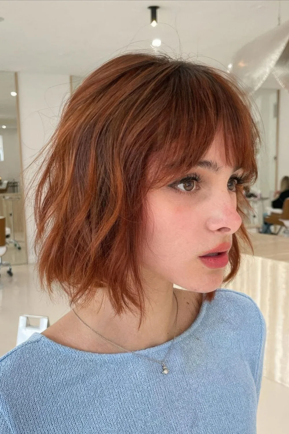 Photo showing wavy ginger cowgirl, with the hairstyle clearly visible.