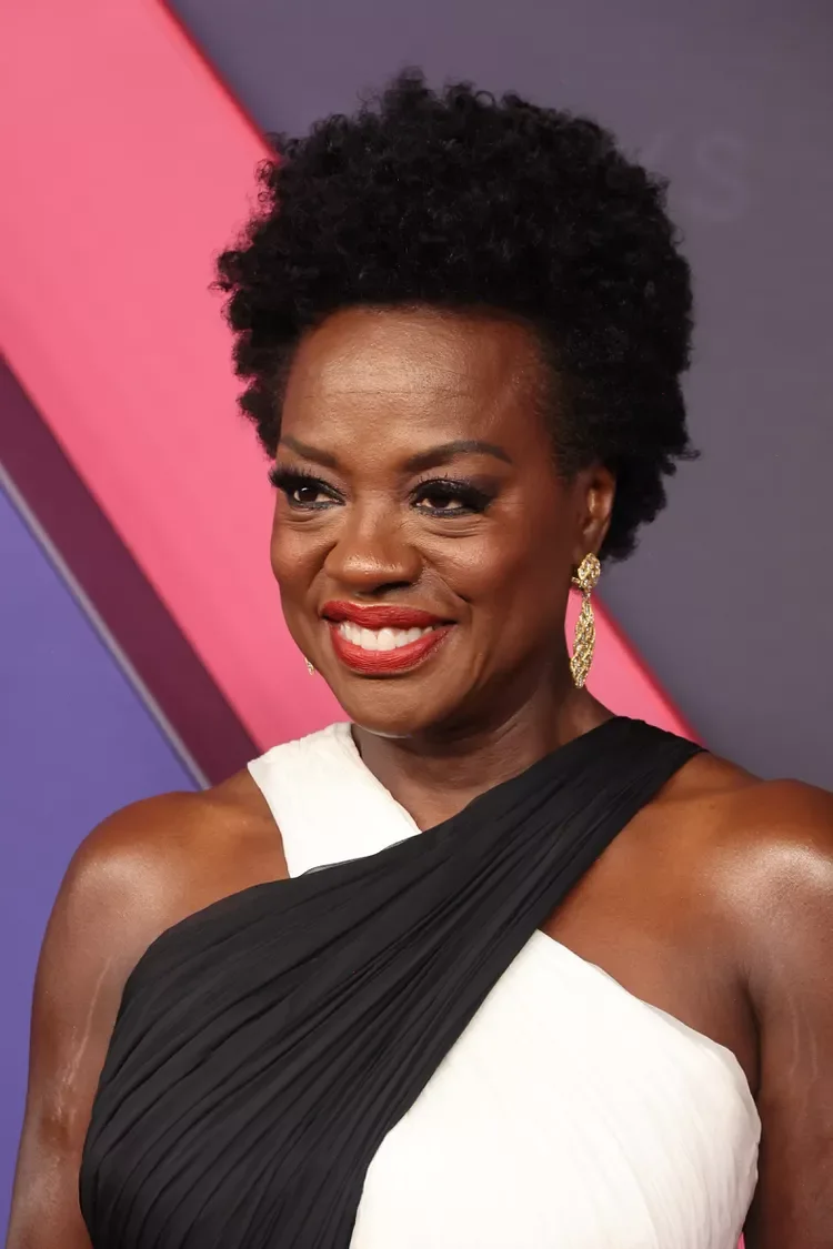 ear coily black curly style shown as a wash and wear haircuts for women over 60 idea, featuring medium layering