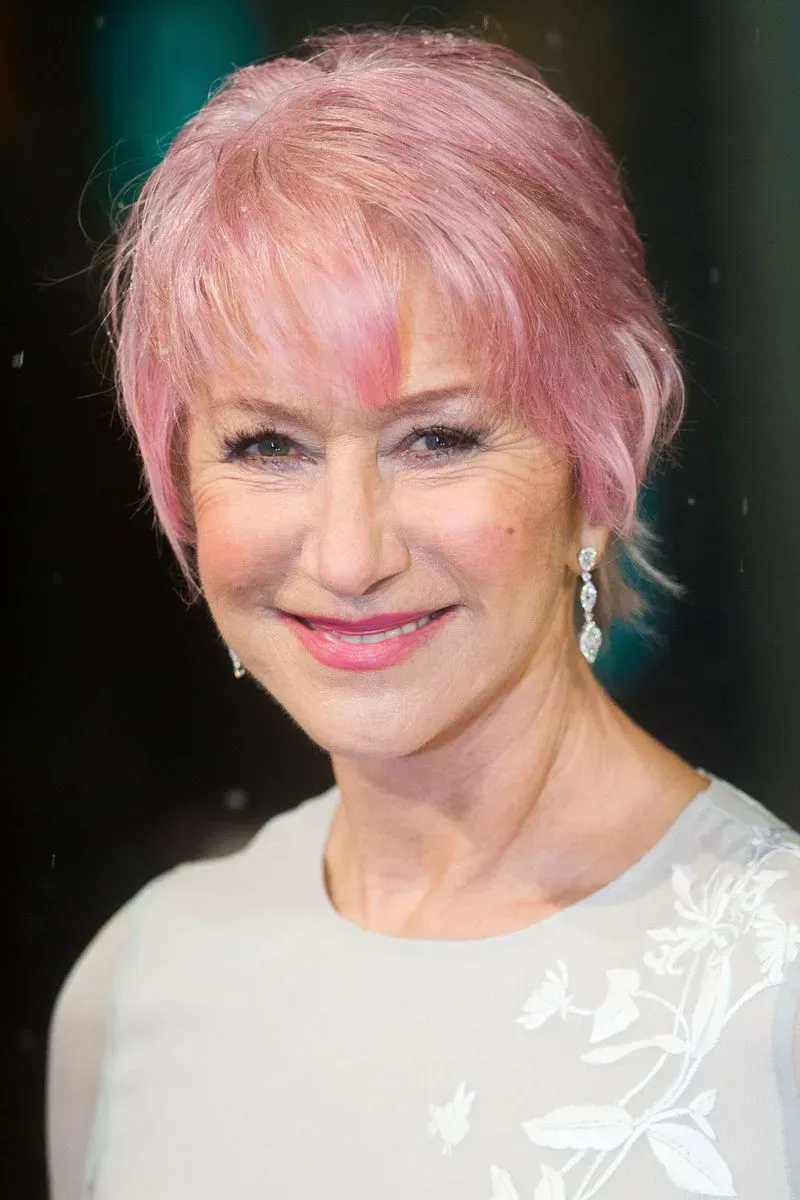 ear straight pink pixie with wispy fringe shown as a wash and wear hairstyles women over 70 thin fine hair idea