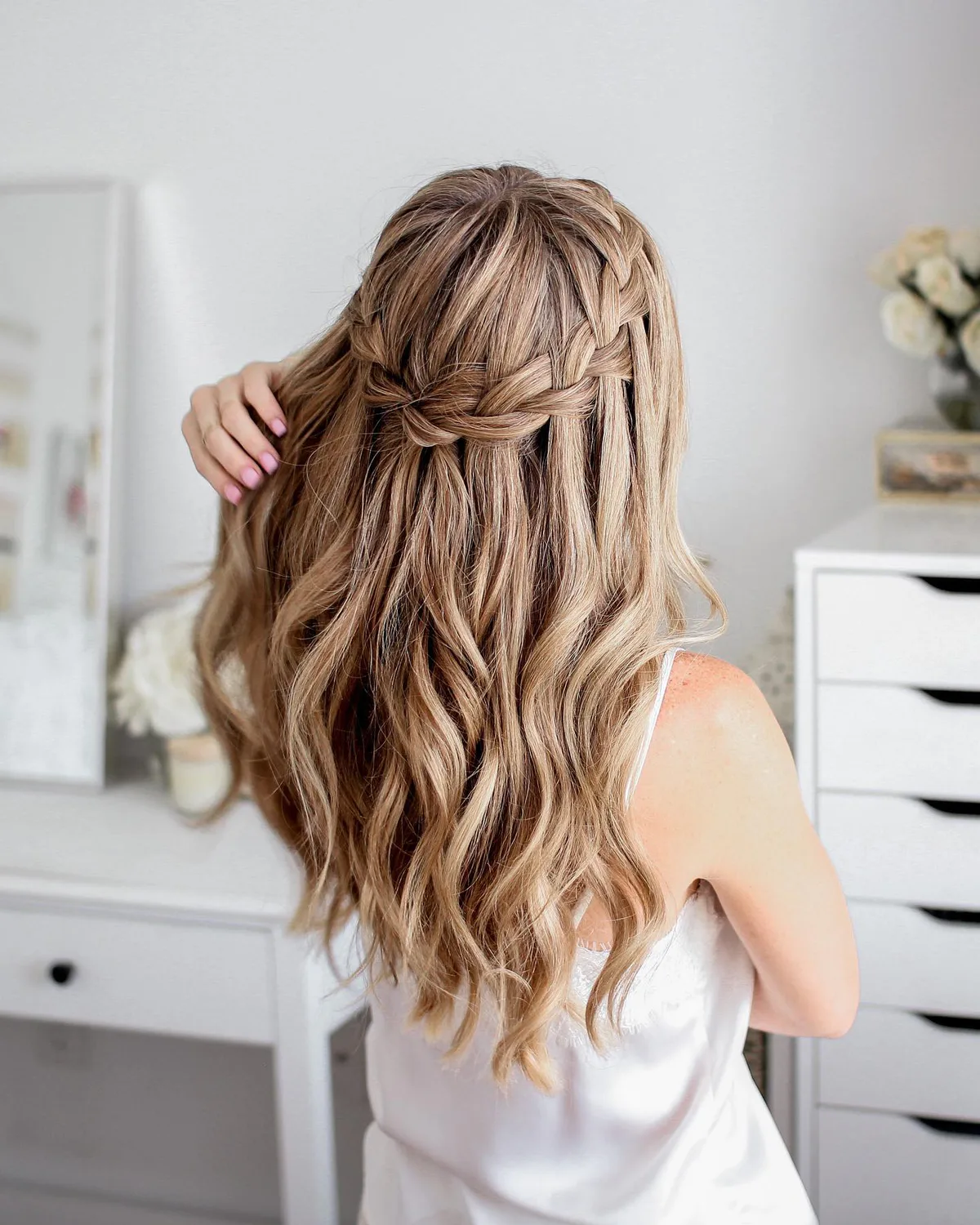 chest braids blonde braid shown as a waterfall hairstyles idea, featuring blonde color, shown in blonde loose waterfall braid