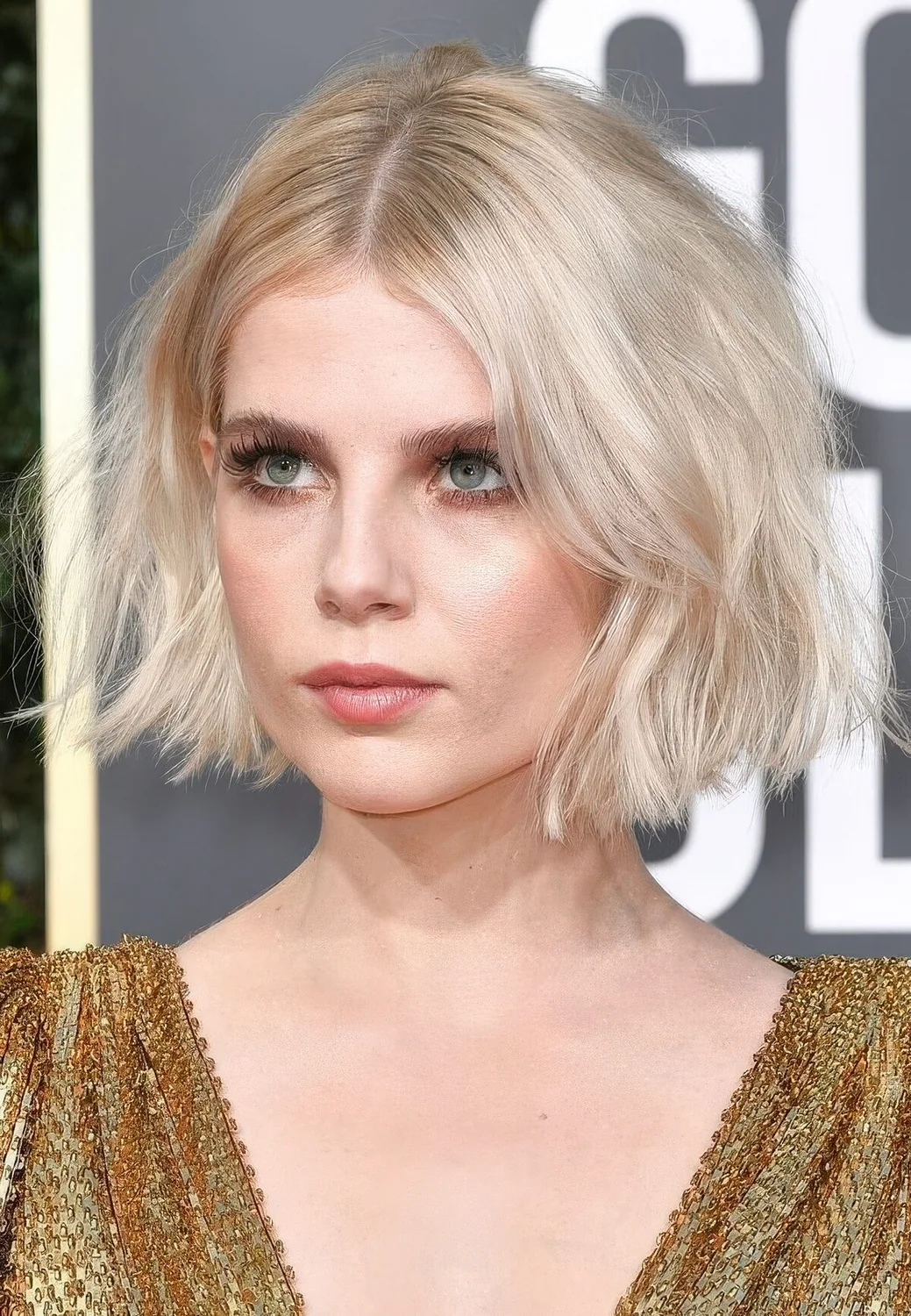 Short blonde bob with much volume and slight waves.