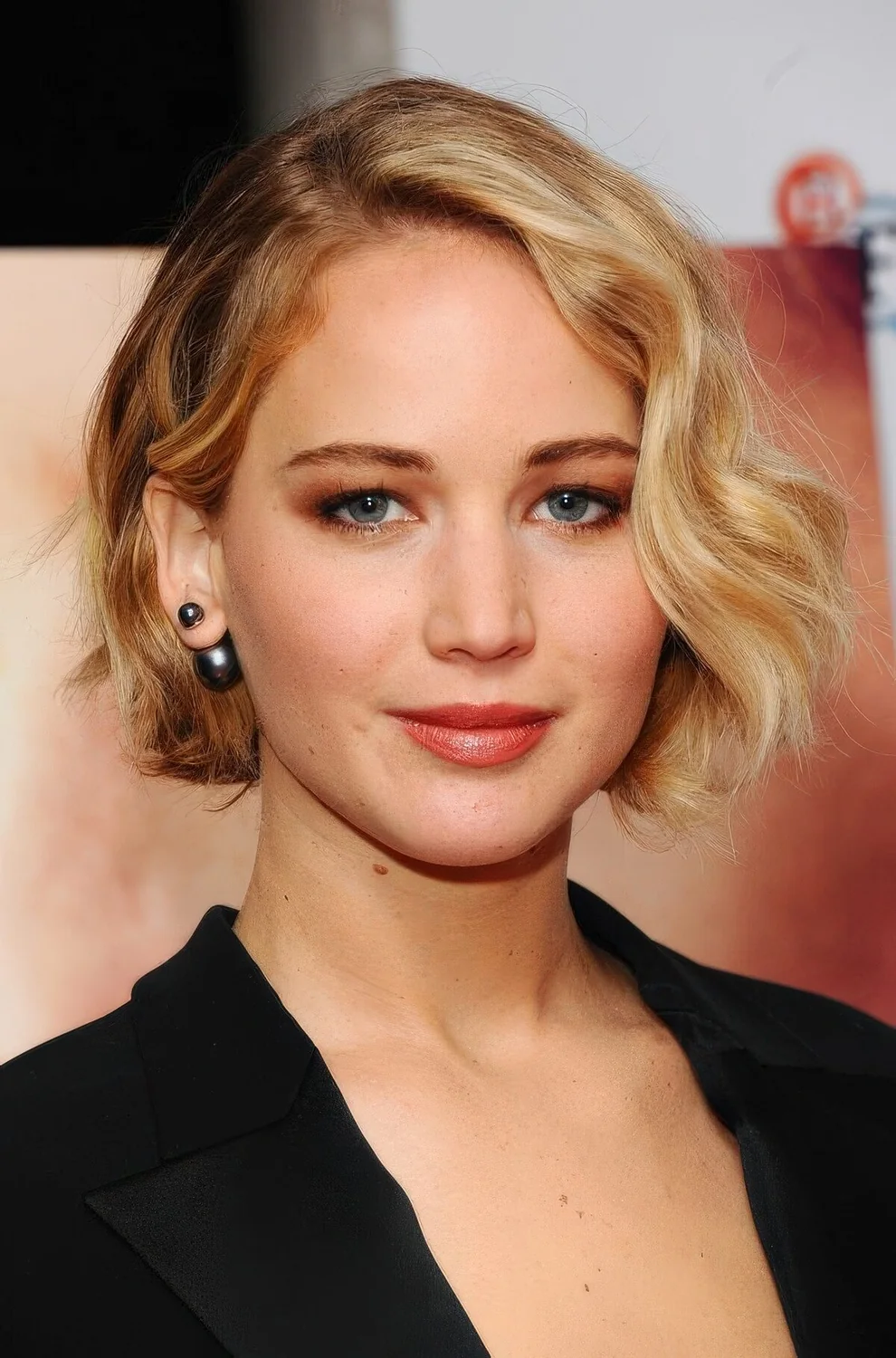 Wavy honey blonde chin-length bob with side part.