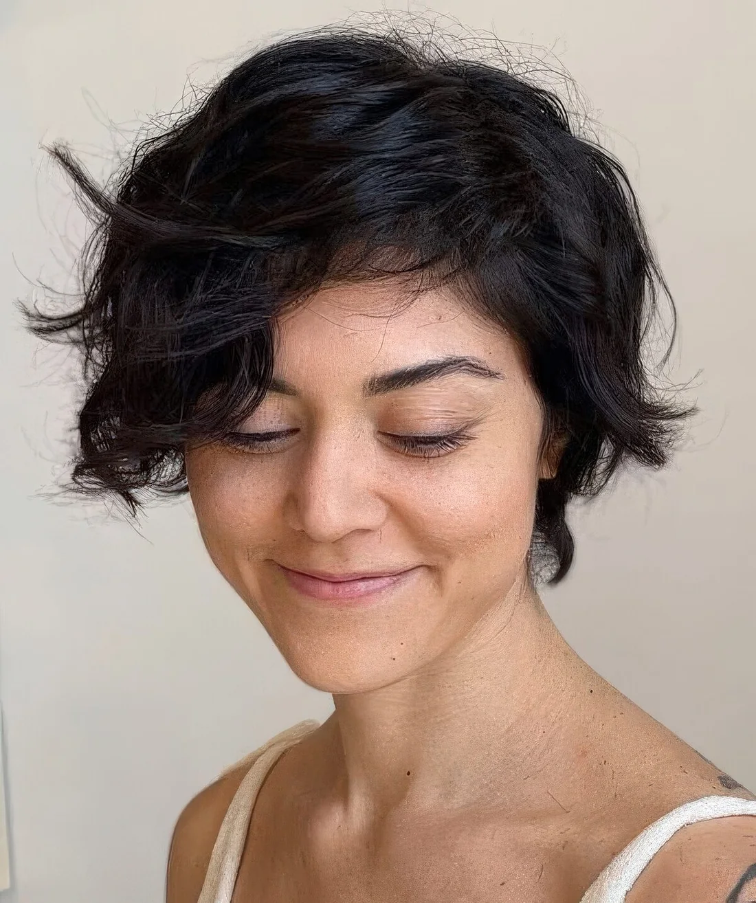 Bixie haircut on black wavy hair and textured ends.