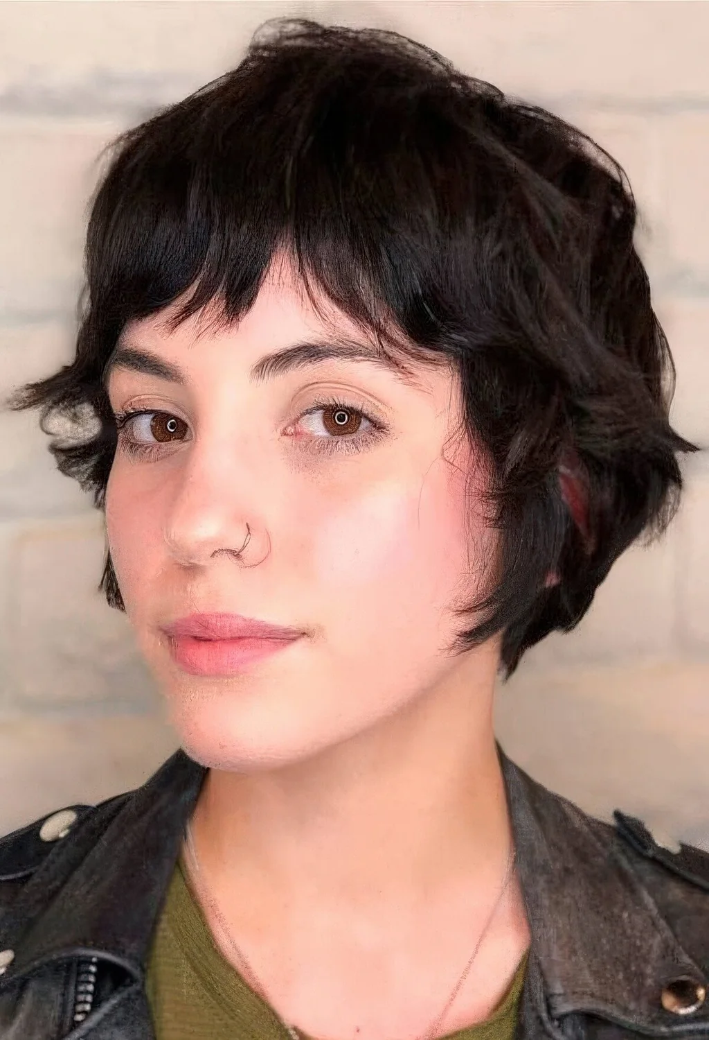 Black wavy bixie with bottleneck bangs.