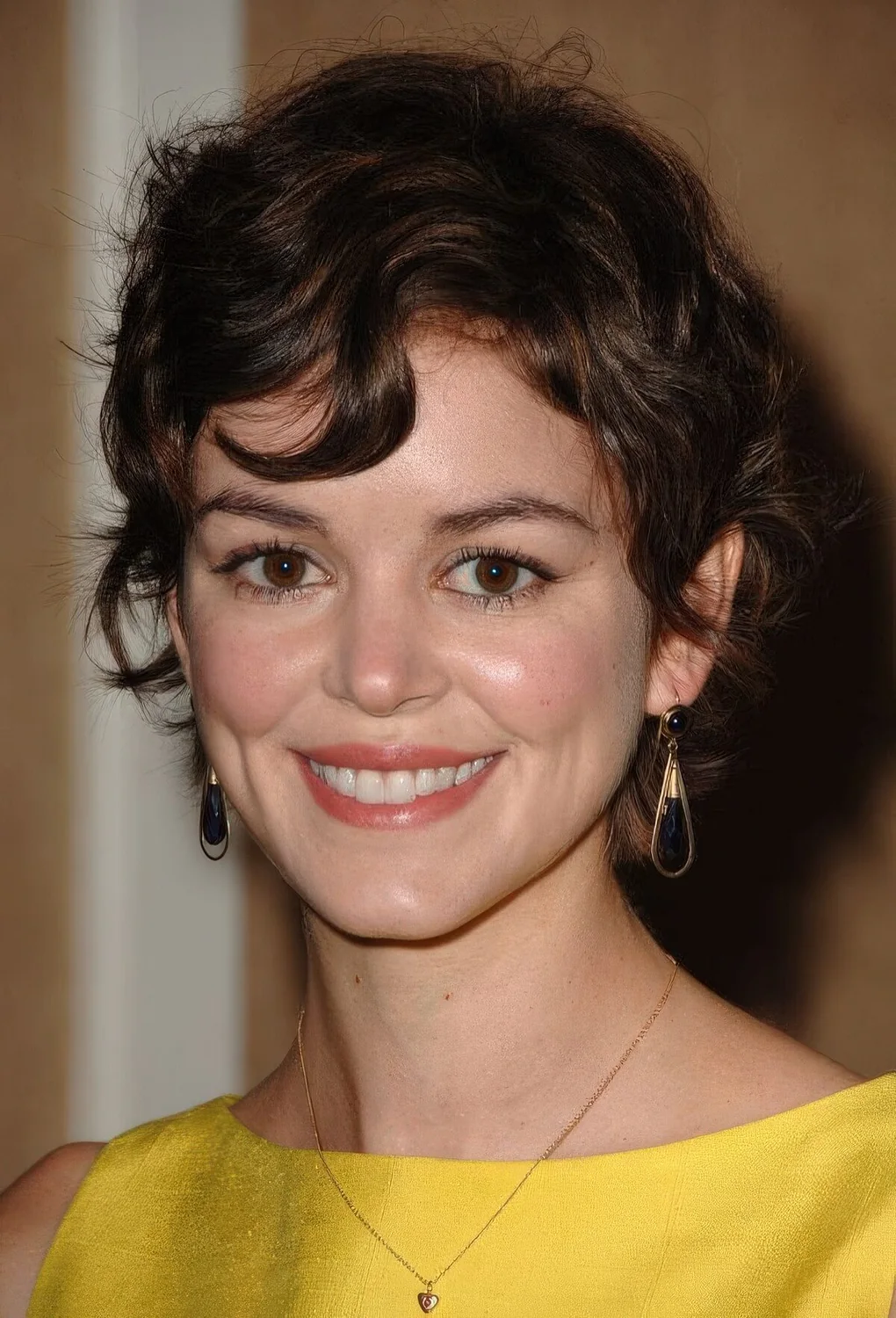Messy brown wavy pixie with a bit of bangs.
