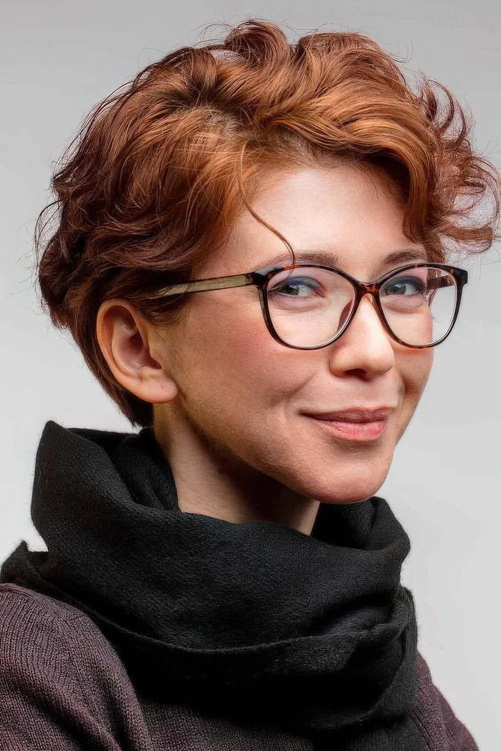 Ginger wavy pixie with short side bangs.