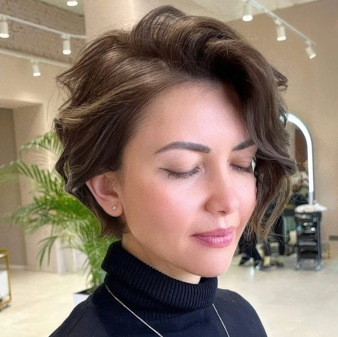 Wavy brown bixie with a lot of volume and side bangs.