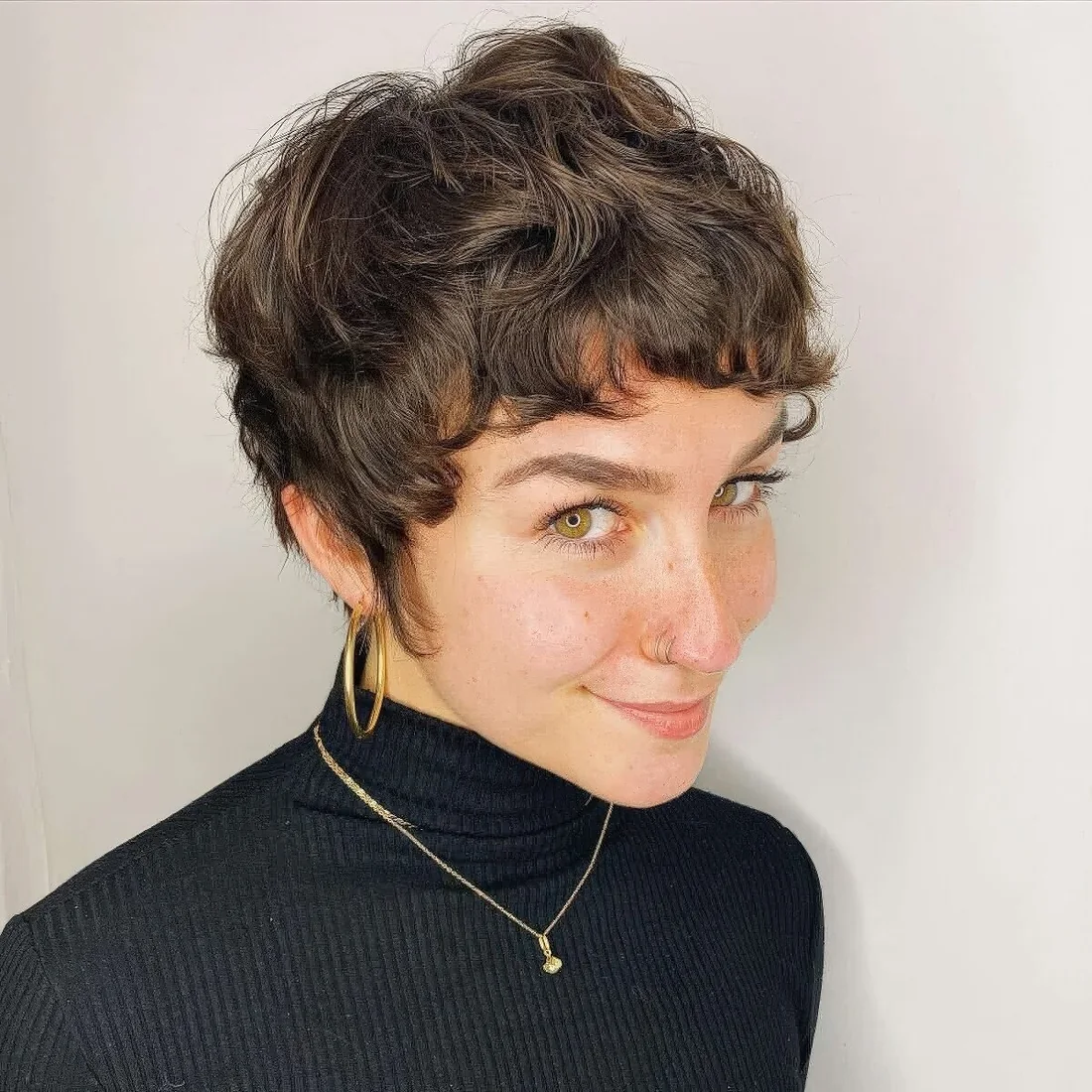 Photo showing short wavy pixie, with the hairstyle clearly visible.