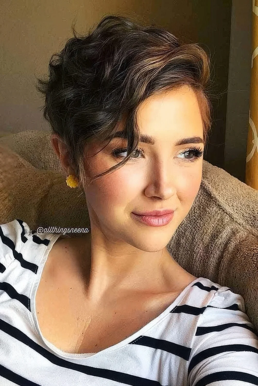 Asymmetrical wavy pixie with side part and a bit of highlights.