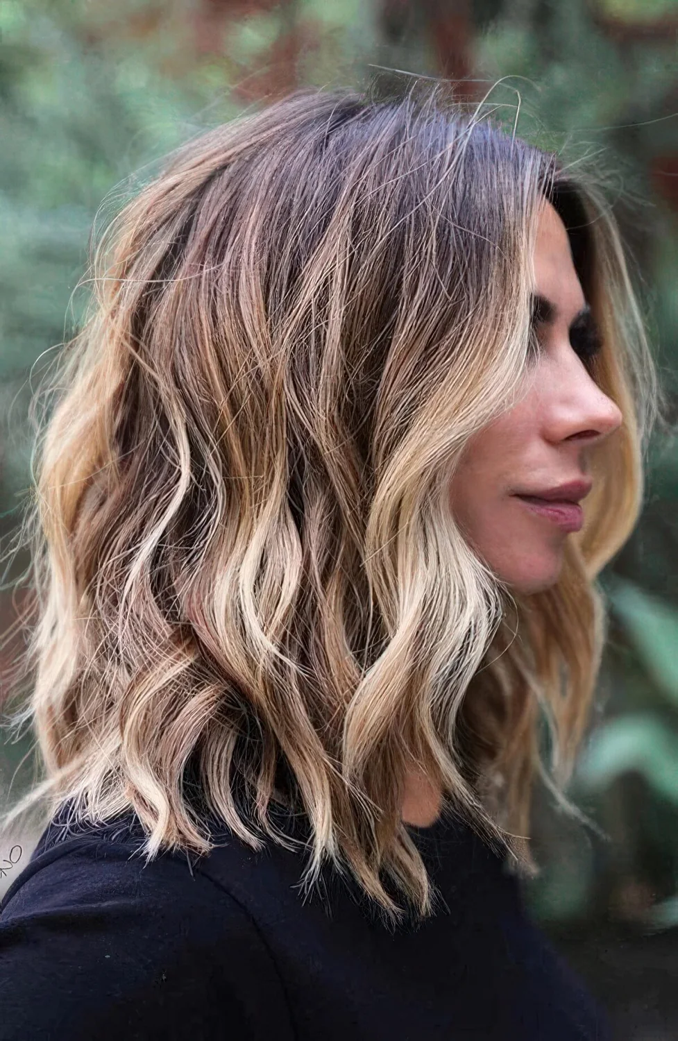 Long bob with blonde and honey colored balayage and waves.