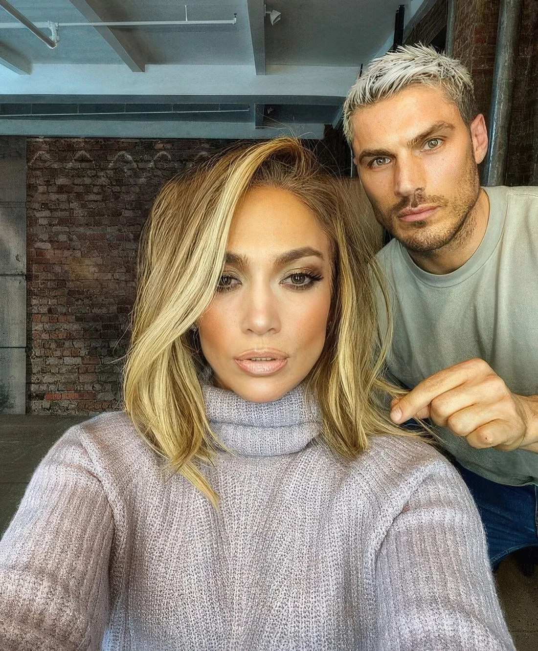 Long shaggy bob with blonde balayage and a long side fringe by J.Lo.