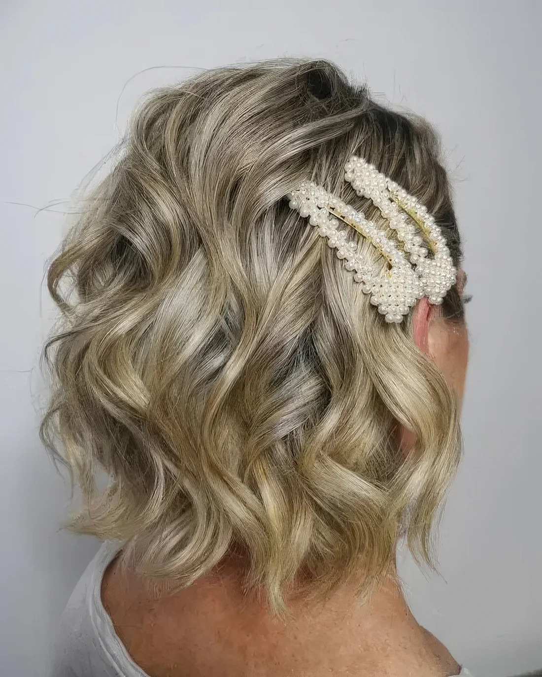 Easy wavy blonde long bob with pearl hair pins.