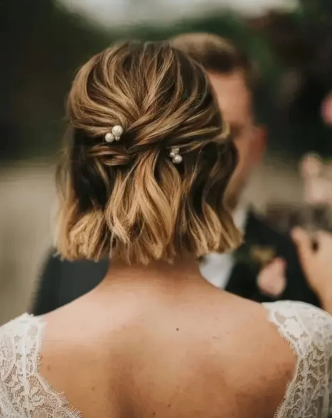 Half updo on shirt hair, with some twists and pretty pearl hairpins.