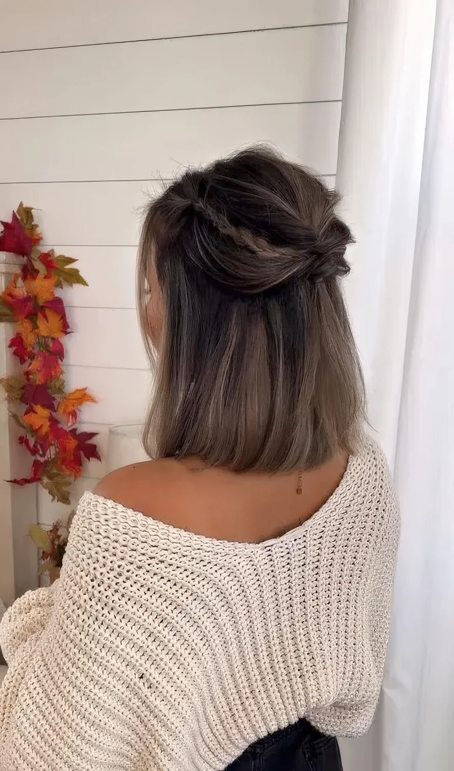 Medium hair half updo with a bump, twists and braids and straight hair down.