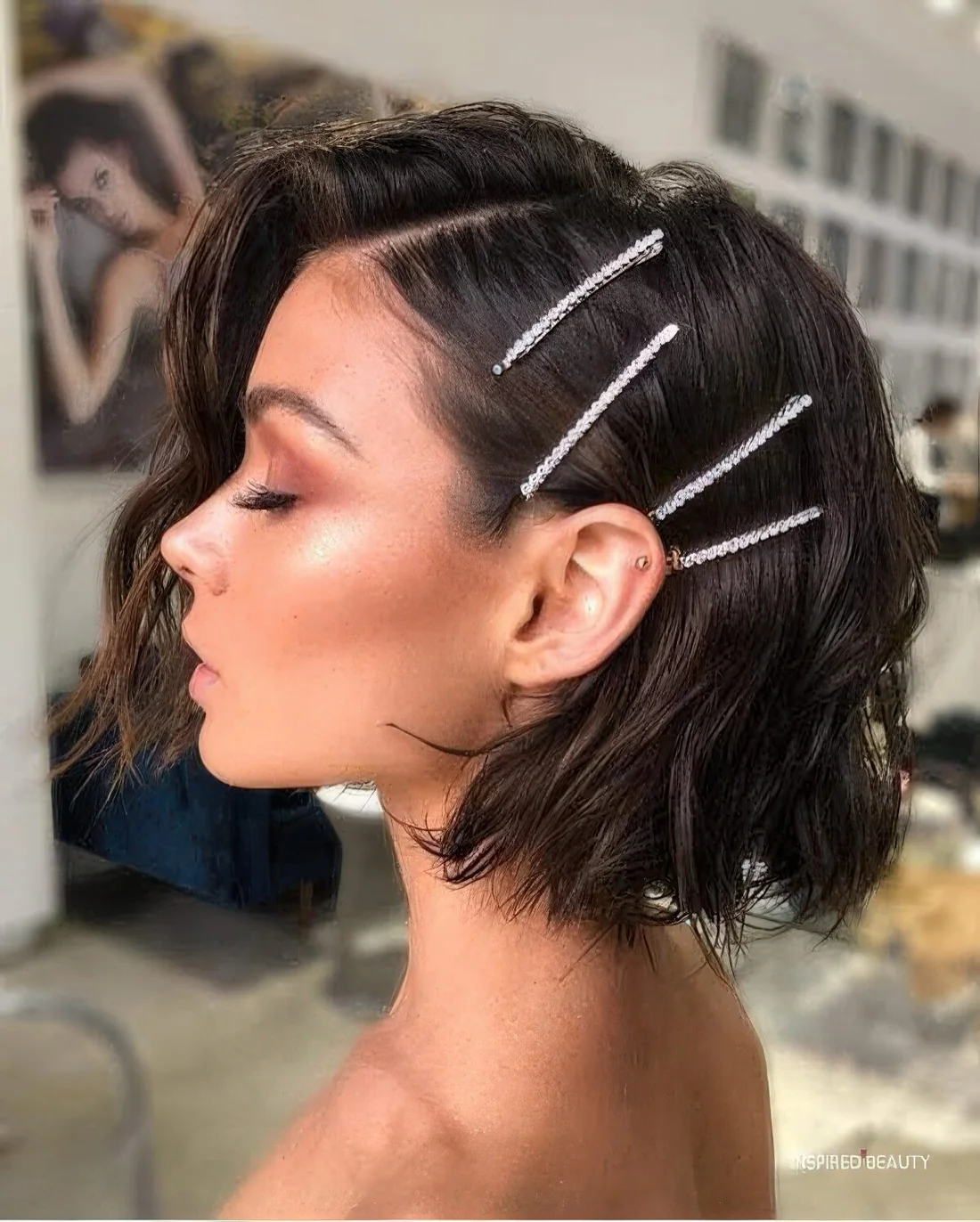 Textured and volumetric midi bob accented with some shiny rhinestone hairpins.