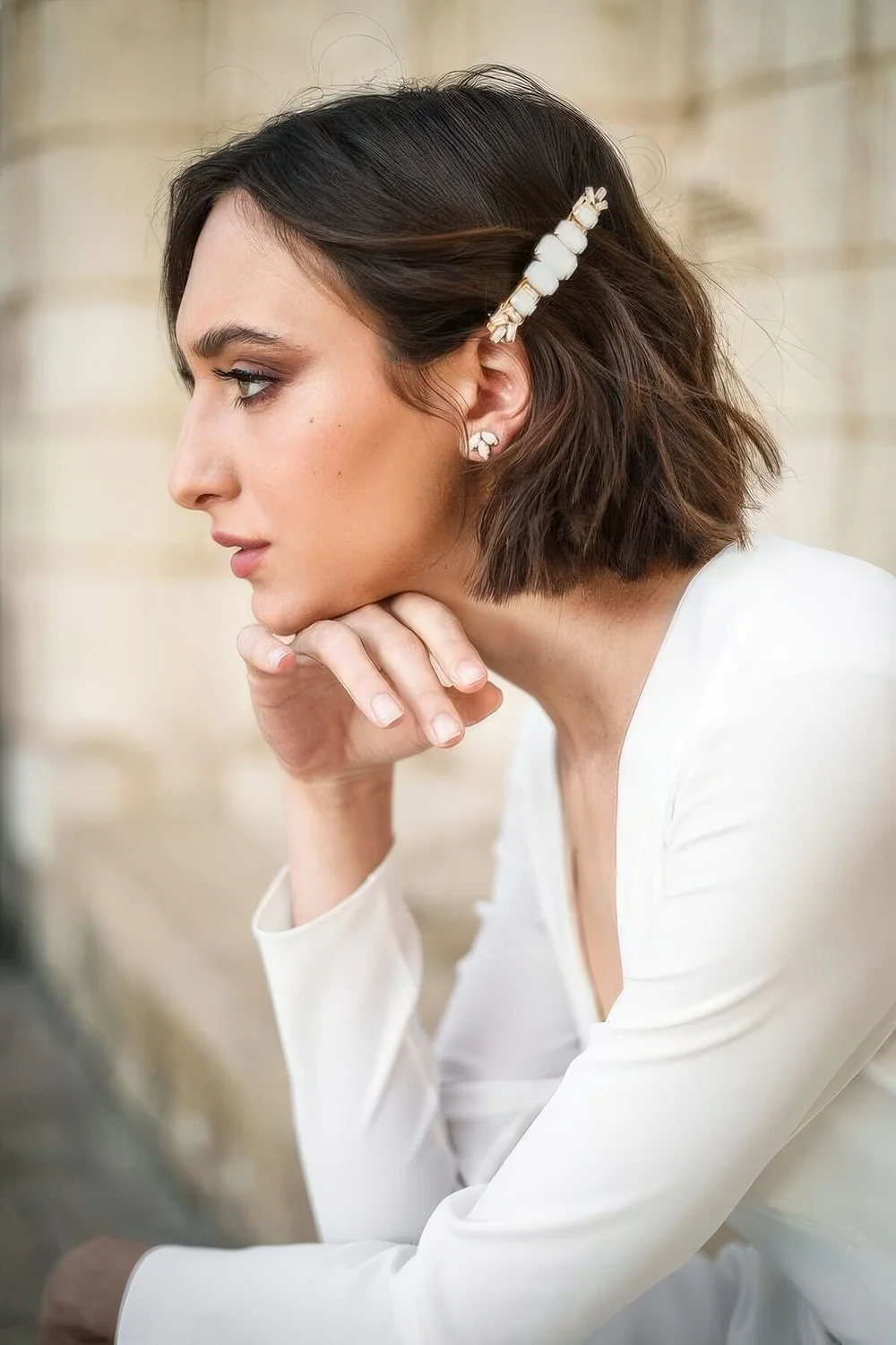 Textured long bob with a gemstone hair barette.